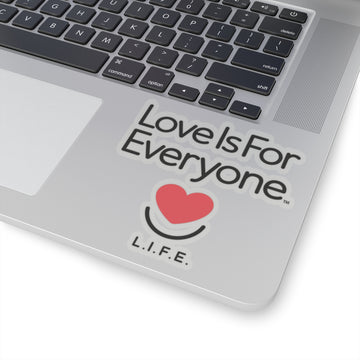 Transparent L.I.F.E. 4x4 "love is for Everyone" vinyl sticker on laptop corner with heart smile logo.