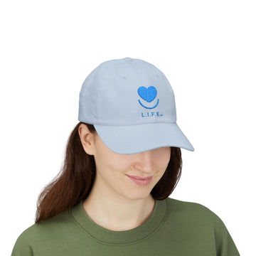 Woman wearing light blue L.I.F.E. embroidered dad hat with heart logo.