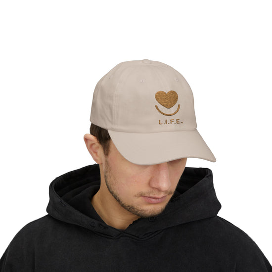 Side view of man wearing stone L.I.F.E. dad hat showing curved visor and minimal logo.