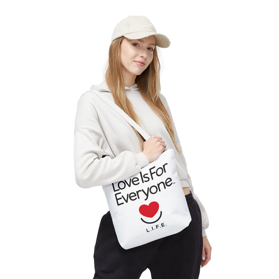 Woman wearing L.I.F.E.Signature tote over shoulder, angled view of positive message.