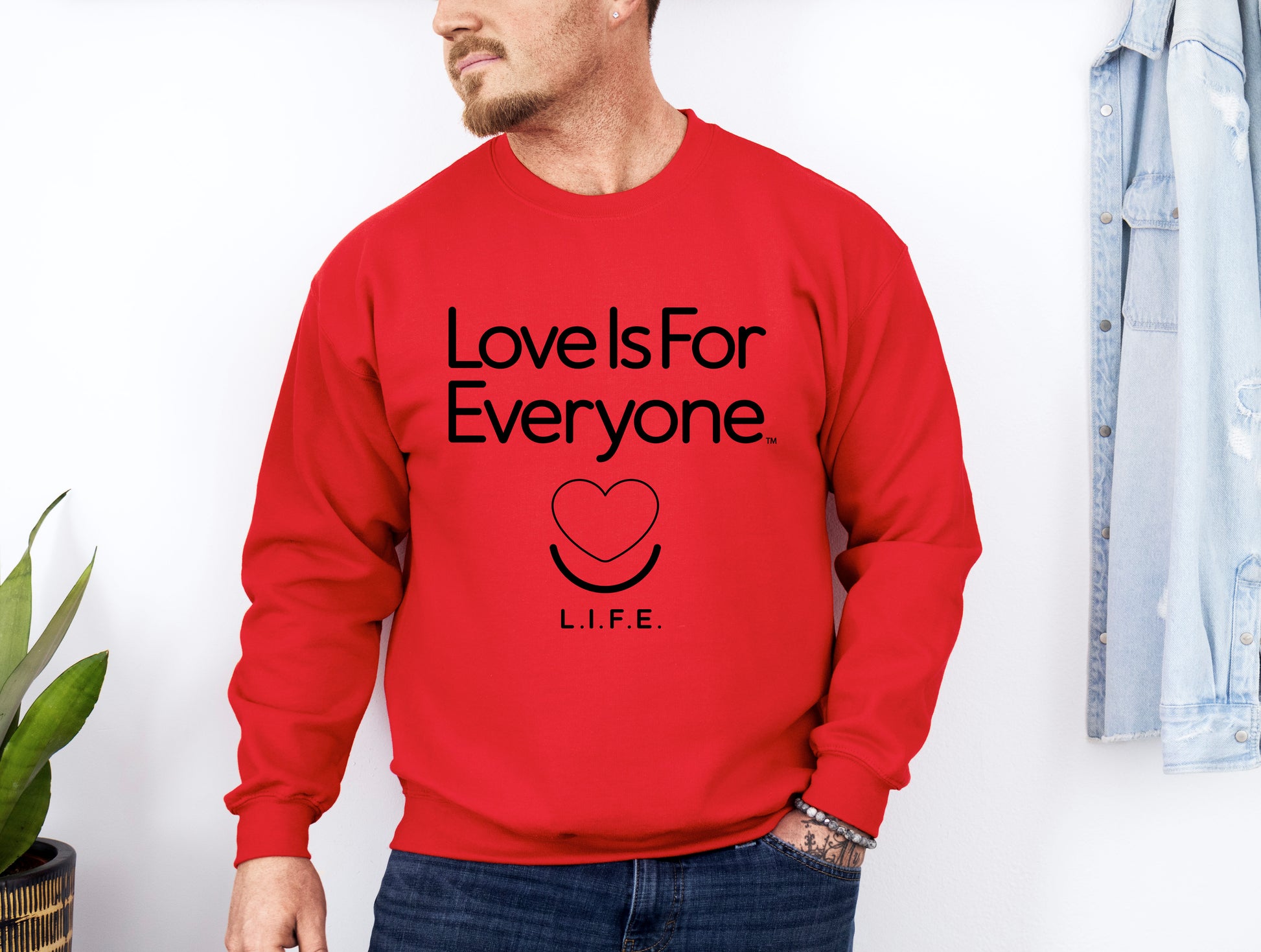 Man wearing men's Classic Crewneck sweatshirt in red, front view with signature L.I.F.E. artwork.