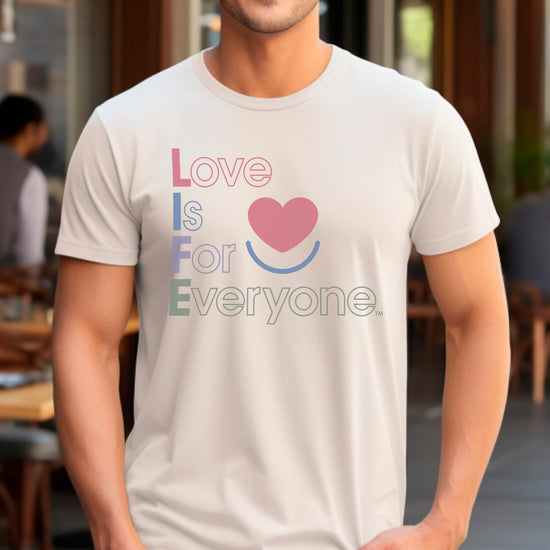 Man wearing sand men's Color Pop graphic tee, front view with vertical design.