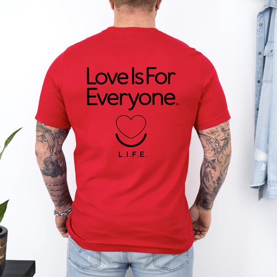 Man wearing men's Signature Tee in red, back view with "Love is for Everyone" graphic.
