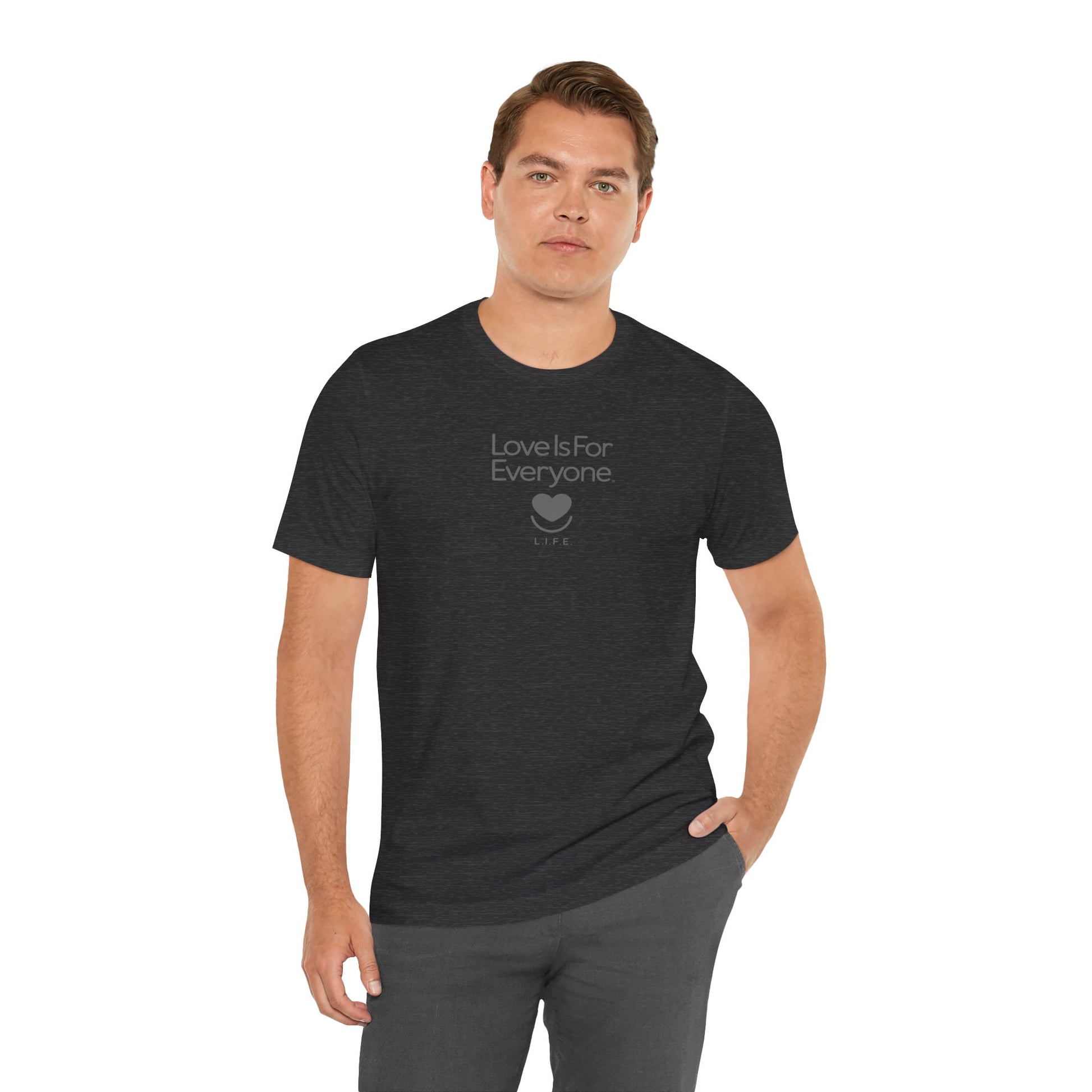 Man wearing men's Strong Spirit Tonal Tee in black, front view with tonal "Love is for Everyone" logo.