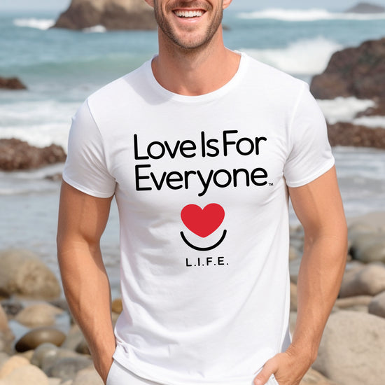 Man wearing men's white Classic Tee, front view with smiling heart and “Love is for Everyone” message.