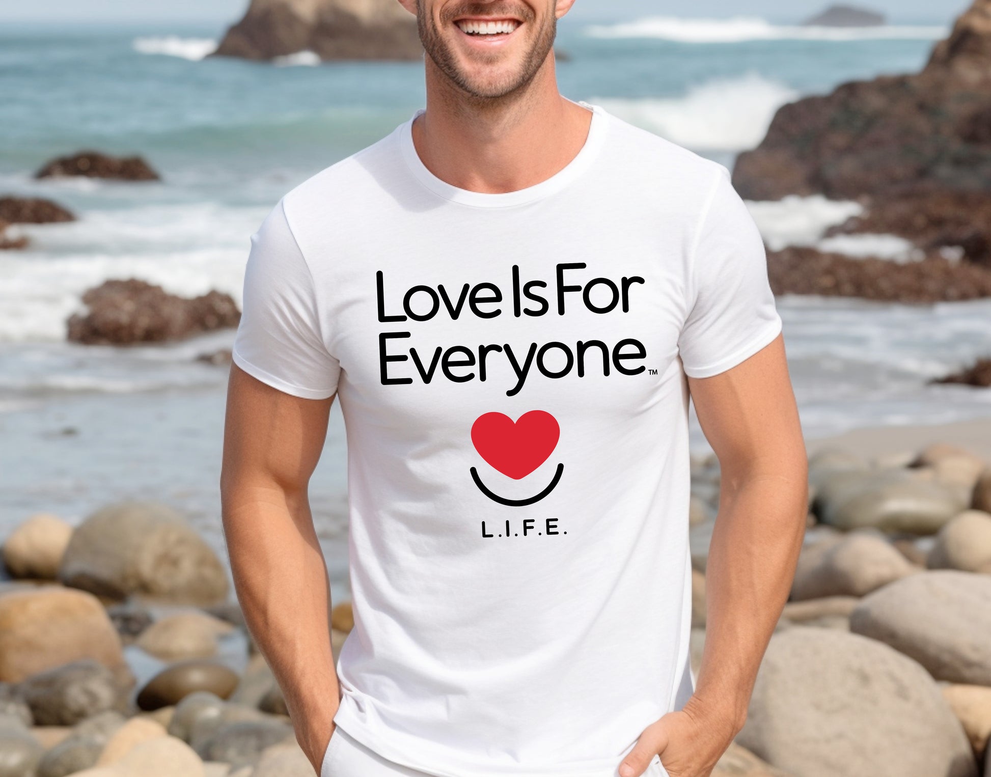 Man wearing men's white Classic Tee, front view with smiling heart and “Love is for Everyone” message.