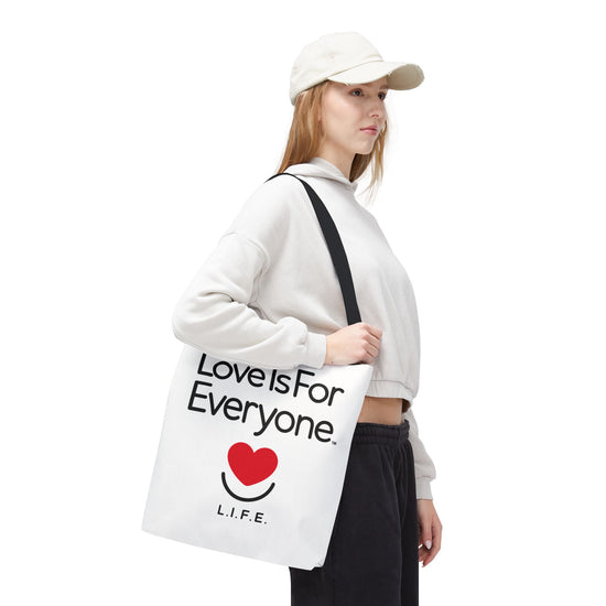 Woman walking with L.I.F.E. Signature tote, contrast black handles.