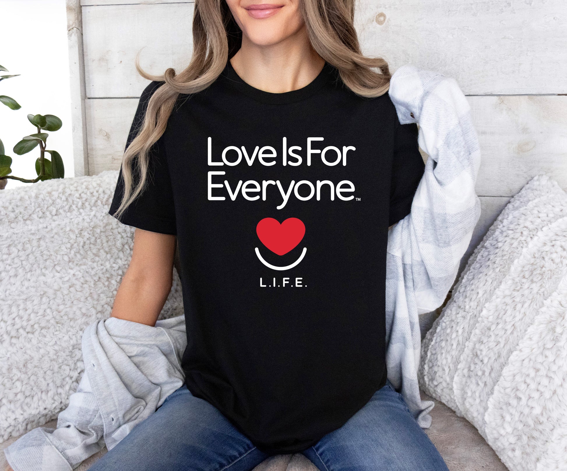 Woman wearing black L.I.F.E. "Love is for Everyone" Classic women's graphic T-shirt.