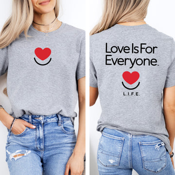 Woman wearing athletic heather L.I.F.E. Signature Tee with smiling heart chest logo.