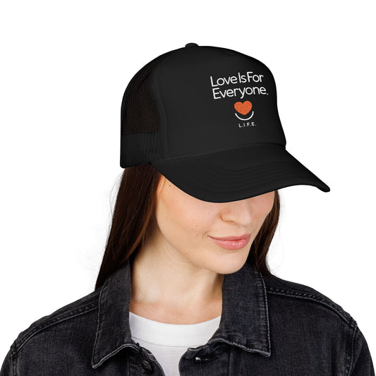 Side view of black L.I.F.E. trucker hat on model showing structured crown and bill. 