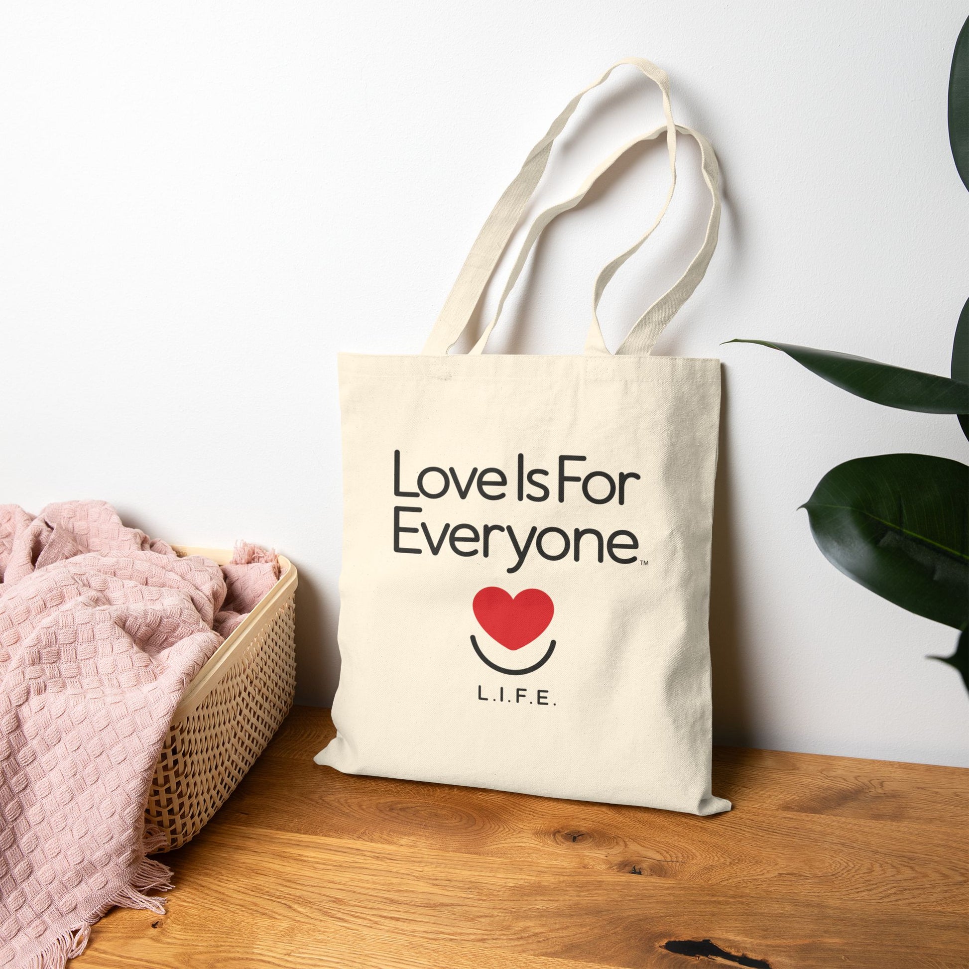 Natural canvas Everyday L.I.F.E. tote on tabletop showing statement print. 