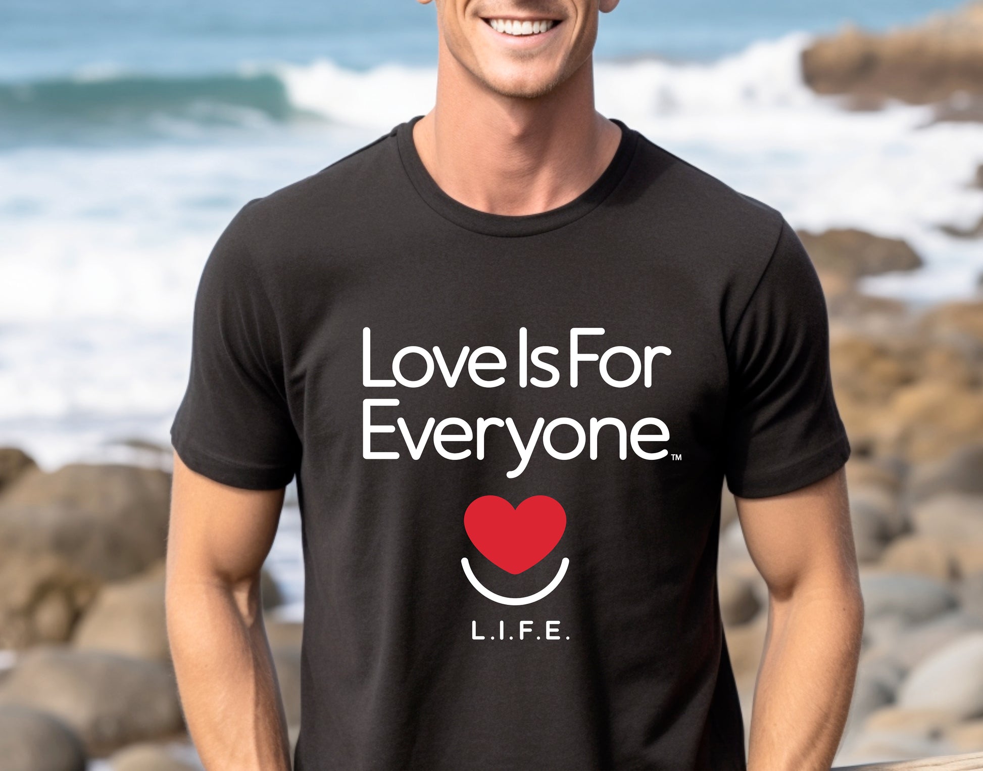 Man wearing men's black Classic Tee, front view with smiling heart logo and L.I.F.E. message. 