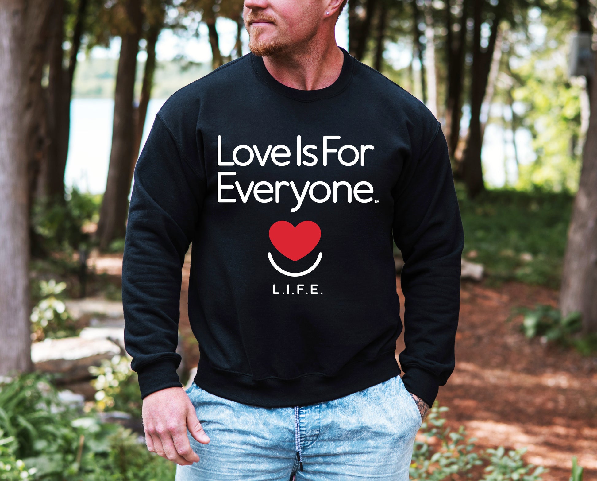 Man wearing men's Classic Crewneck sweatshirt in black, front view with signature L.I.F.E. artwork. 