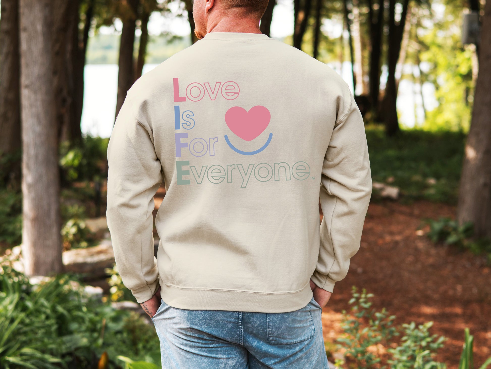 Man wearing men's Color Pop sand crewneck, back view vertical L.I.F.E. statement message. 