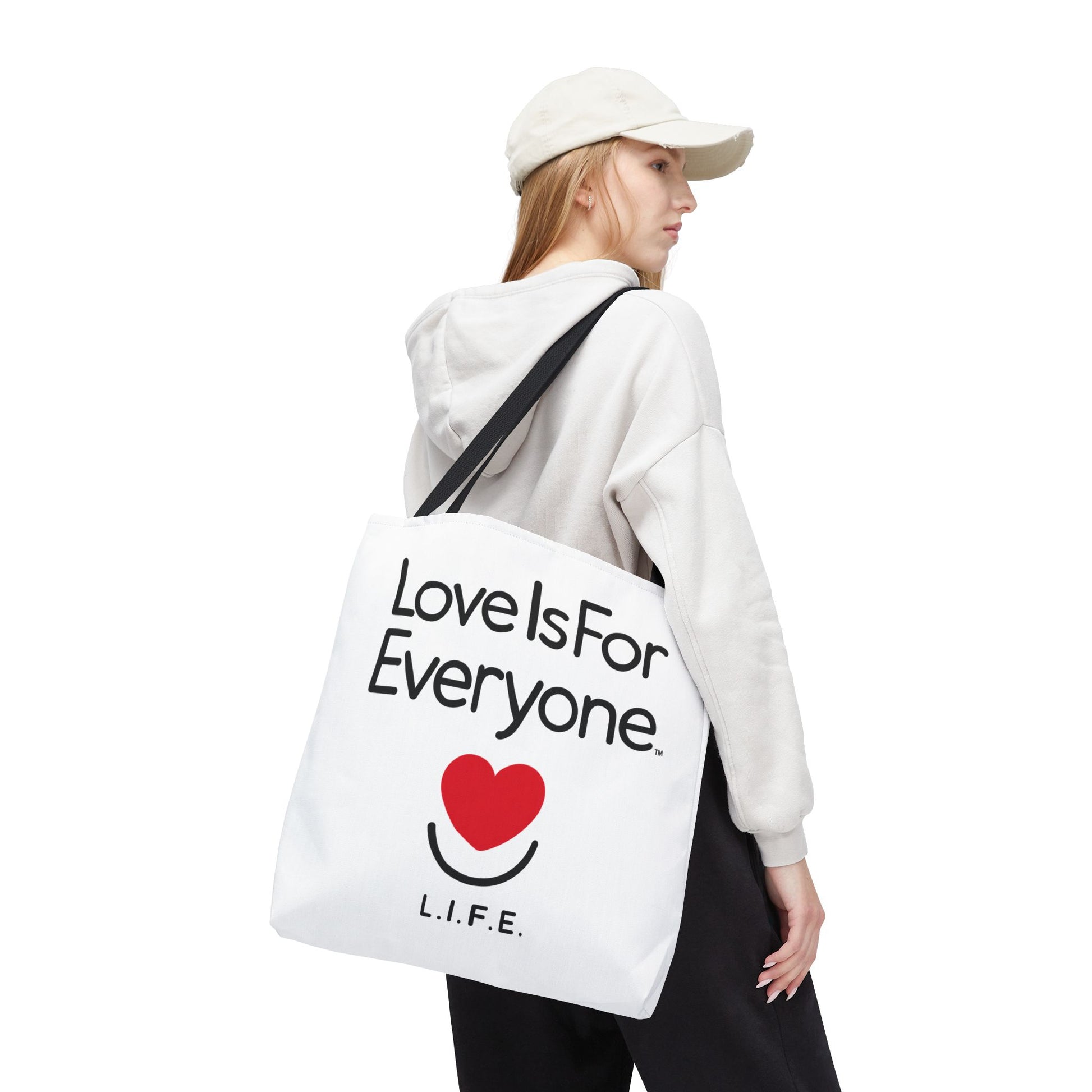 Woman walking with 18'x18" Signature L.I.F.E. tote bag white with black contrast handles. 