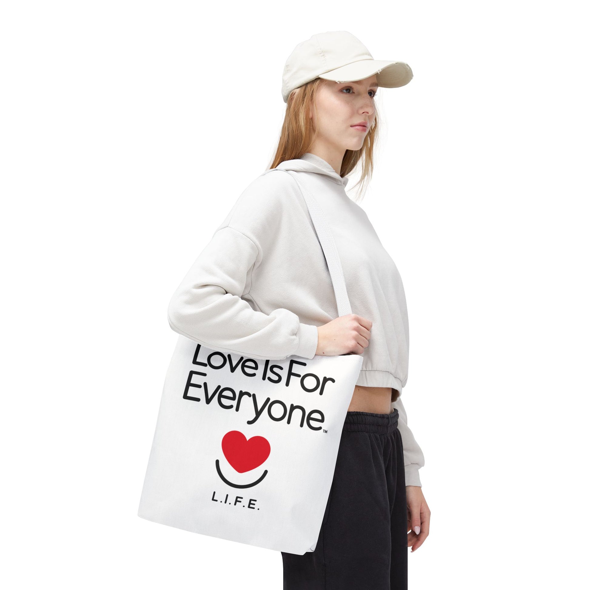 Woman walking with white L.I.F.E. Signature tote and white reinforced handles. 