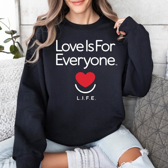 Woman wearing women's Classic Crewneck in black, front view with L.I.F.E. signature graphic.