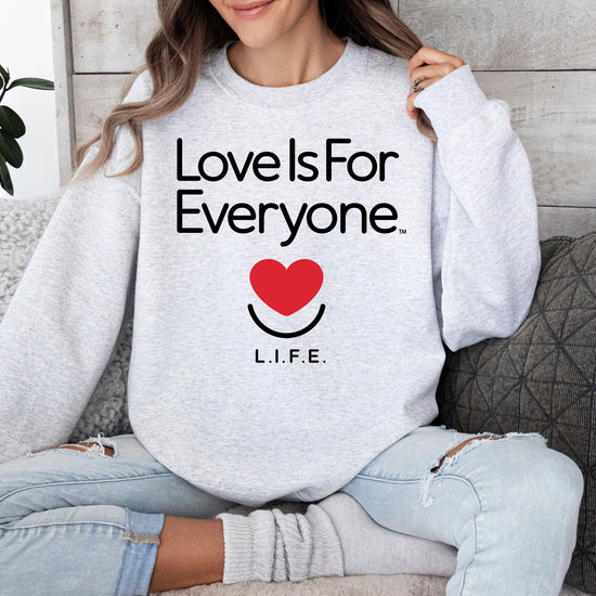 Woman wearing women's Classic Crewneck in grey, front view with L.I.F.E. signature graphic. 