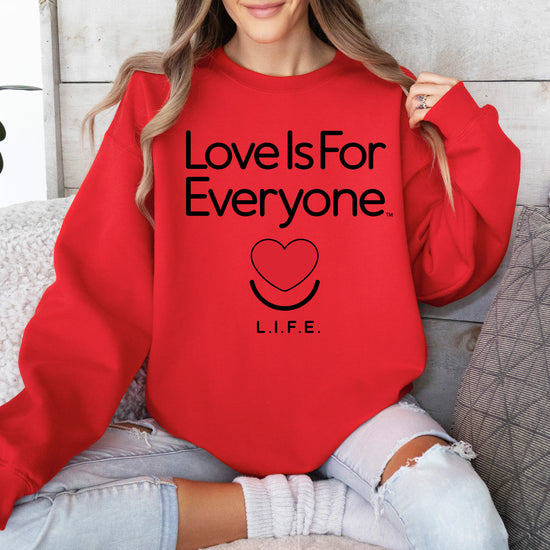 Woman wearing women's Classic Crewneck in red, front view with L.I.F.E. signature graphic.