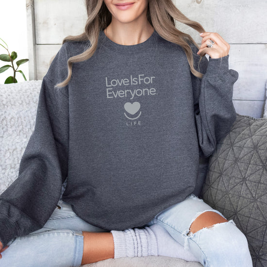 Woman wearing grey L.I.F.E. Soft Spoken Tonal graphic sweatshirt with tone-on-tone message. 