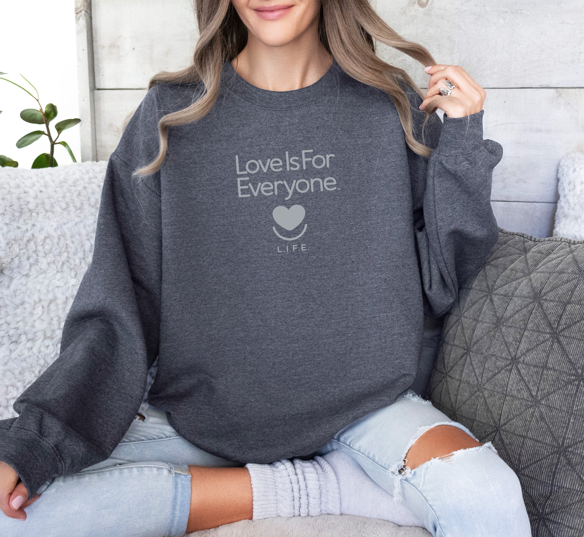 Woman wearing grey L.I.F.E. Soft Spoken Tonal graphic sweatshirt with tone-on-tone message. 