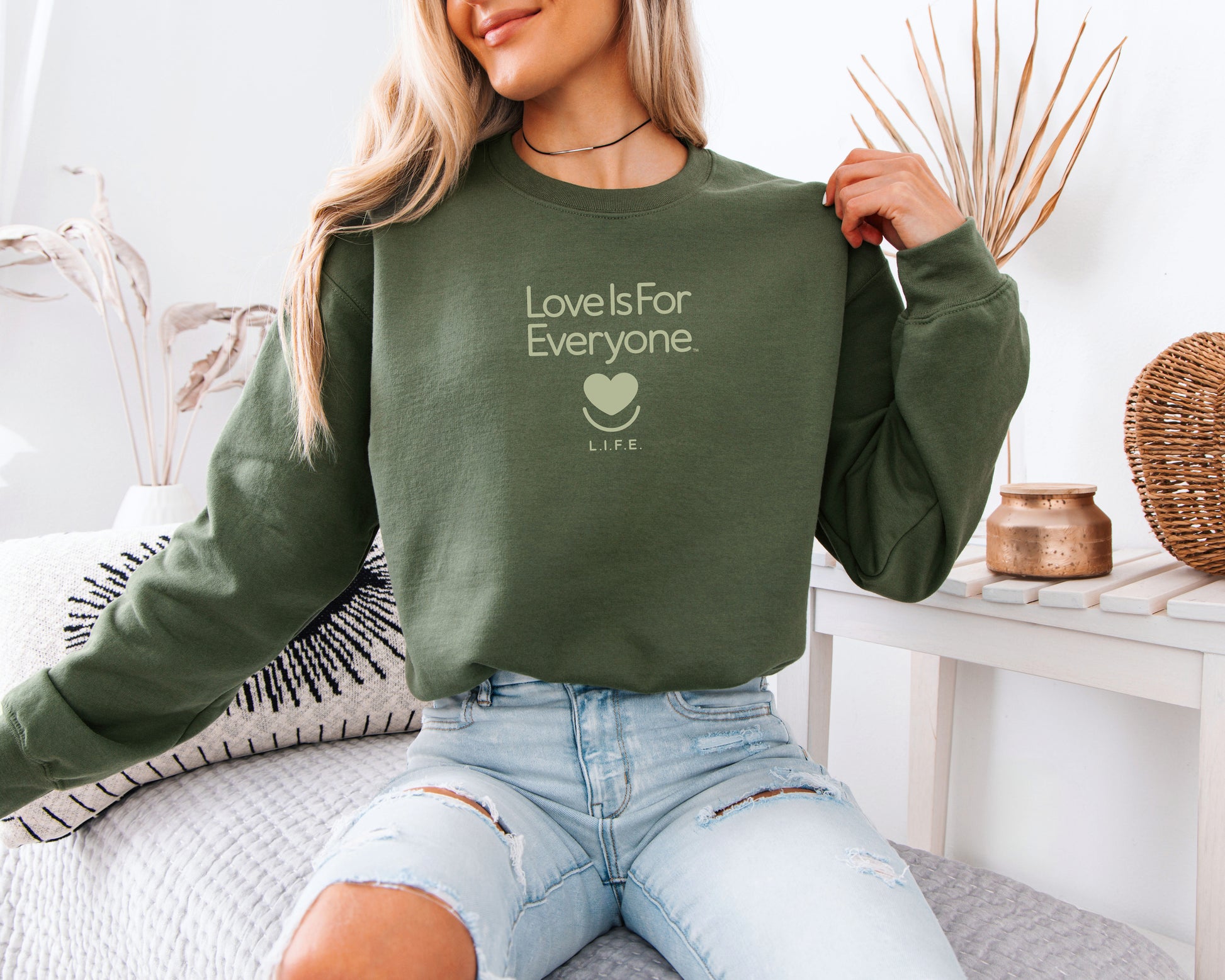 Women in military green L.I.F.E. Soft-Spoken Tonal crewneck, relaxed fit and minimal tonal print.