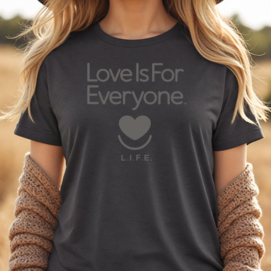 Woman wearing grey heather L.I.F.E. Strong Spirit Tonal graphic T-shirt with tone-on-tone print.