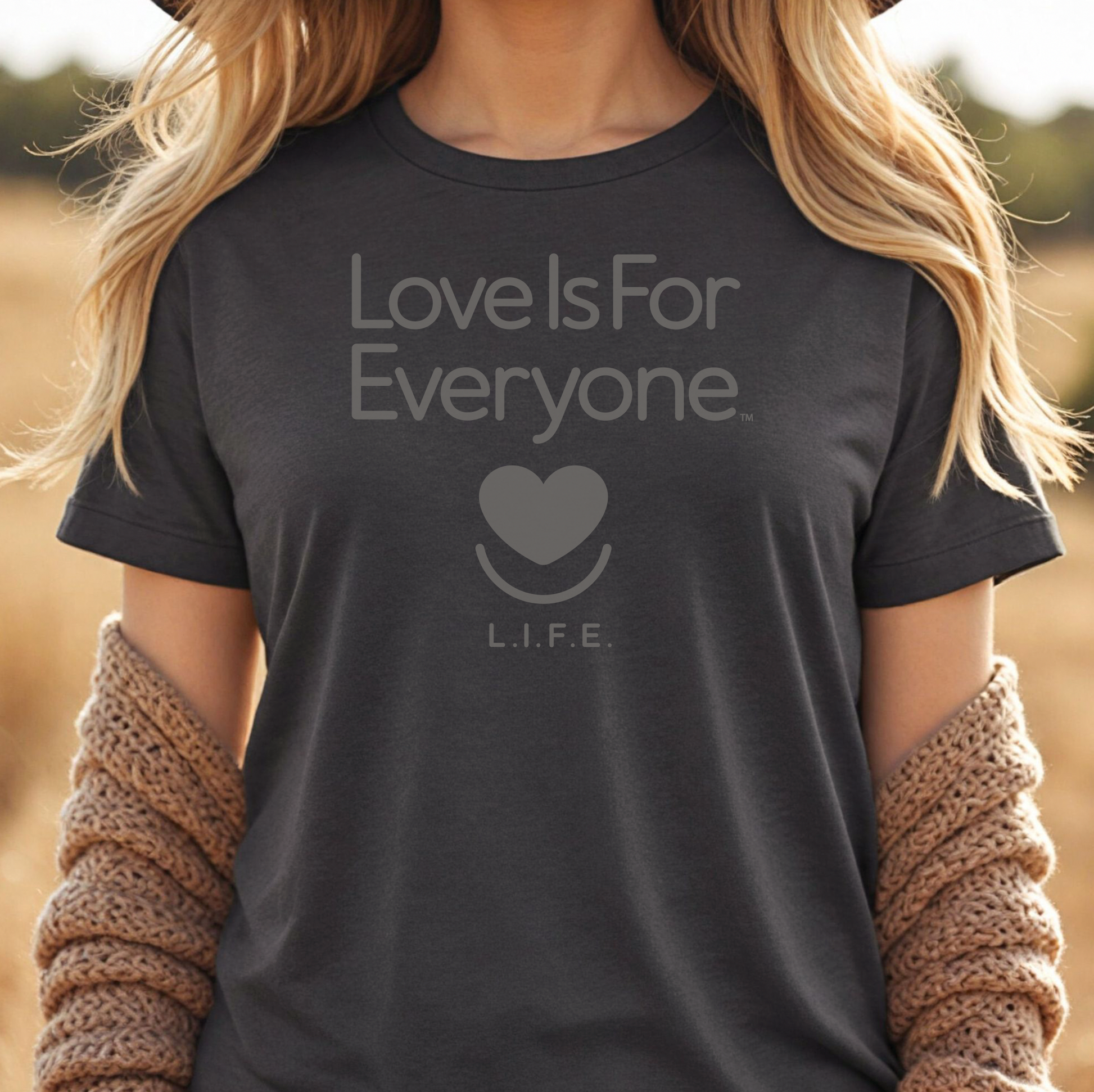 Woman wearing grey heather L.I.F.E. Strong Spirit Tonal graphic T-shirt with tone-on-tone print.