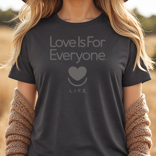 Woman wearing grey heather L.I.F.E. Strong Spirit Tonal graphic T-shirt with tone-on-tone print.