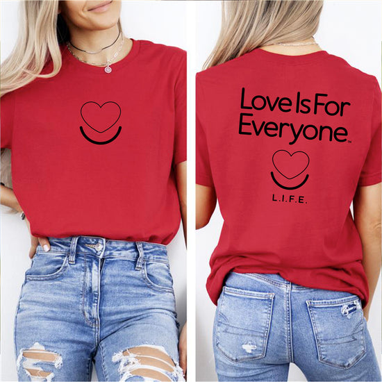 Woman wearing women’s Signature “Love is for Everyone” Tee, center chest heart logo and vertical text on back 